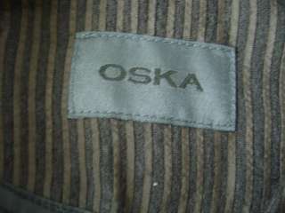 It is a black and brown pinstripe with one button and sleeves that 