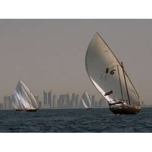  Dhow Sailboats Glide and Race across Waters of the Arabian Gulf 