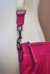 Description Fuschia leater with canvas strap. Top zipper with front 