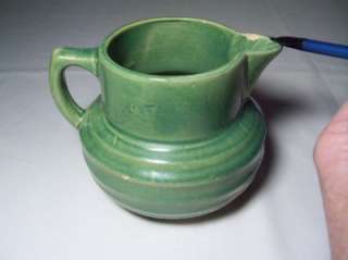 This is a vintage 1926 McCoy buttermilk pitcher. Marked on the bottom 