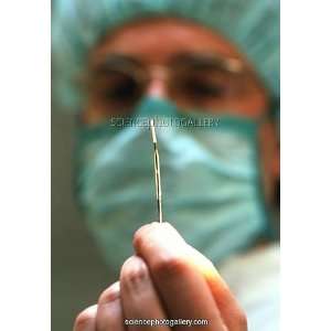  Surgeon holding a stent for dilating heart artery Framed 