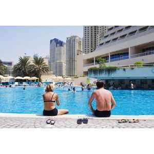 Couple Sitting by a Swimming Pool in the 40 Degree Heat by Christian 