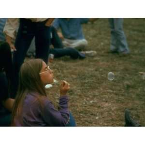 Jackie Barg Sitting on the Ground and Blowing Bubbles, During the 