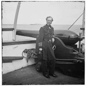   Dahlgren standing by a Dahlgren gun on deck of U.S.S.