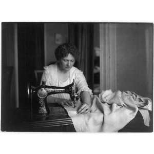  Woman sewing with a Singer sewing machine