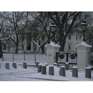 Christmas Wreaths Add a Touch of Color to Snow Covered White House 